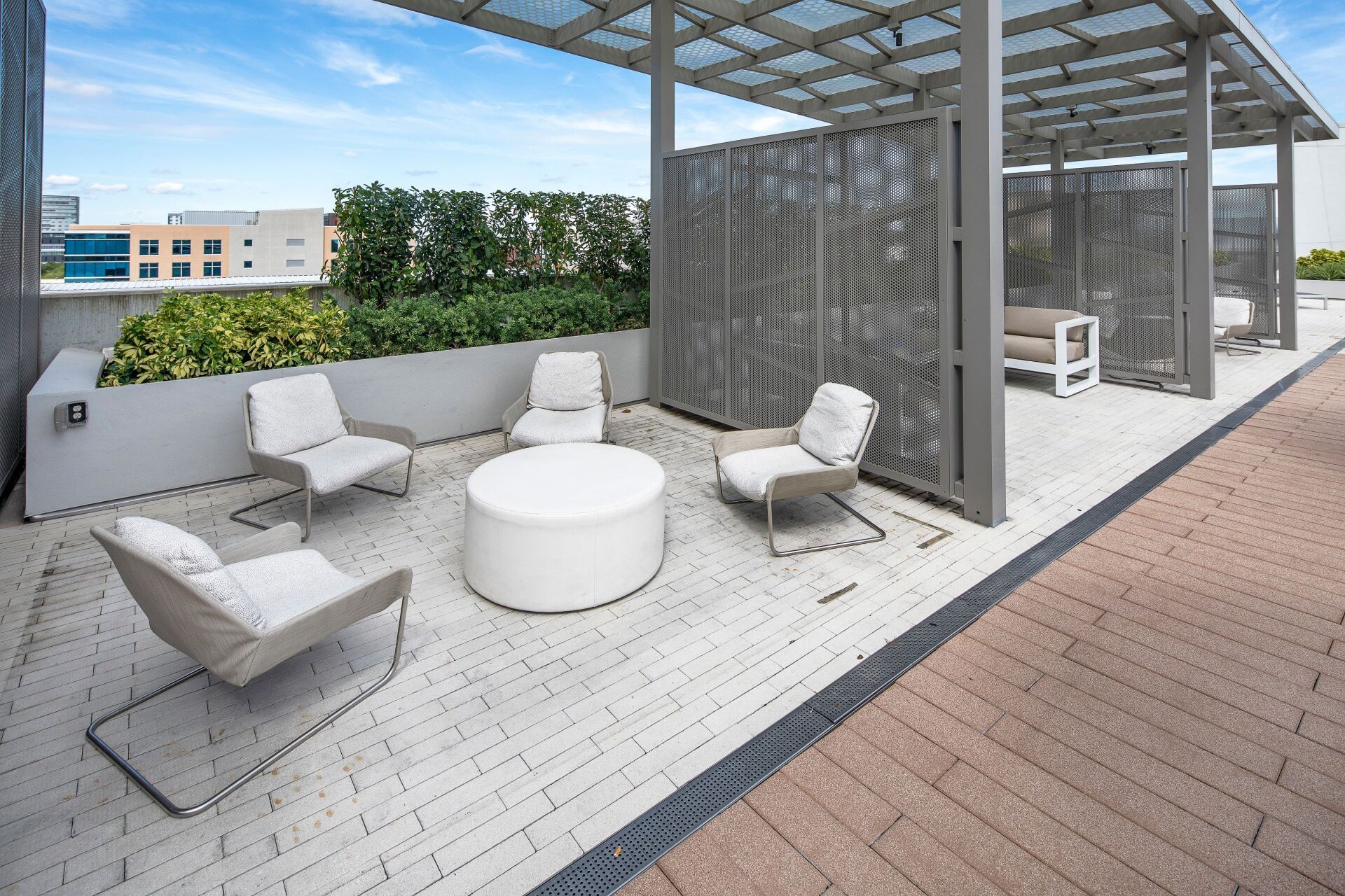 A patio with chairs and a table under a canopy.