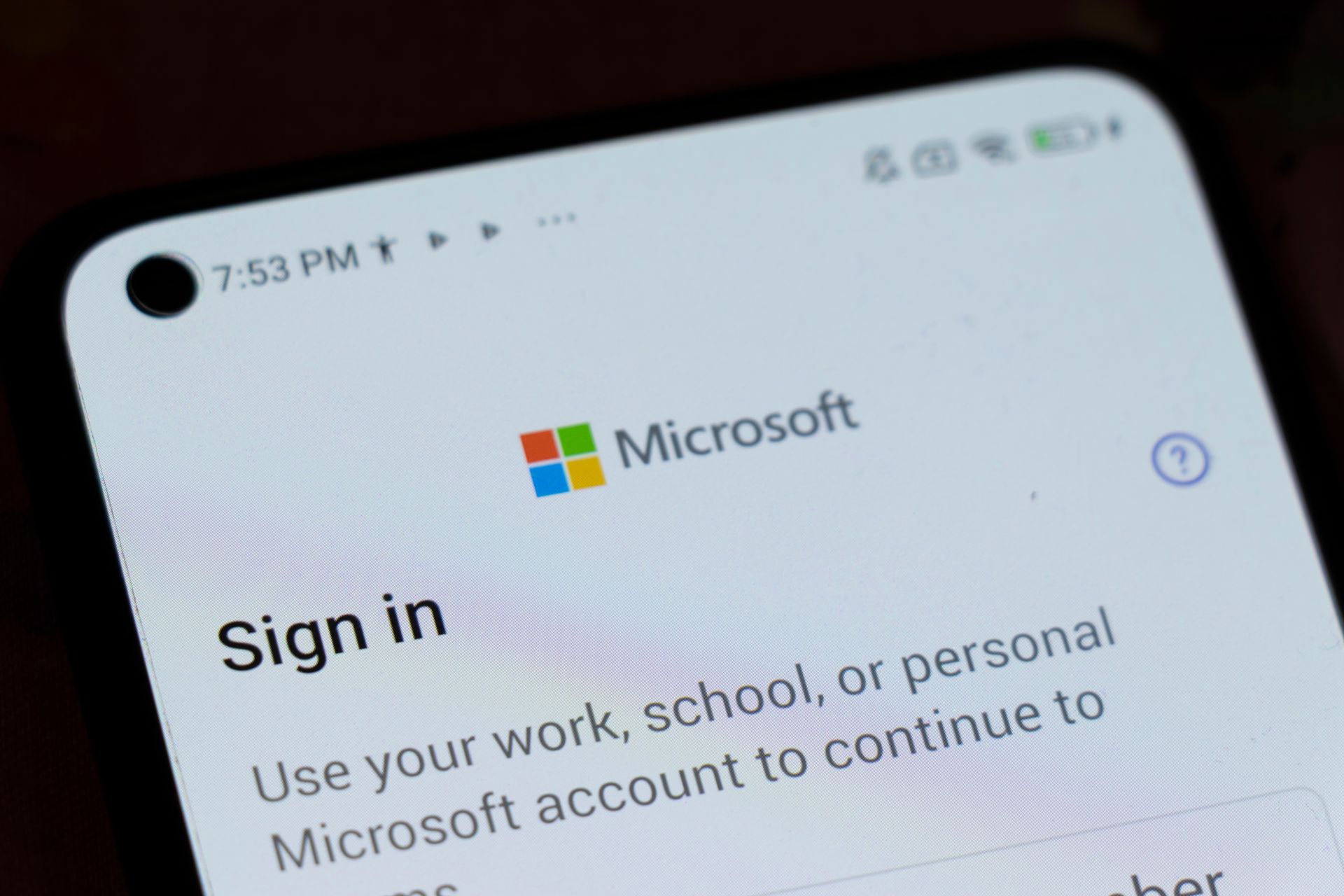 Microsoft sign-in screen on a phone showing the Microsoft logo and “Sign in” text.