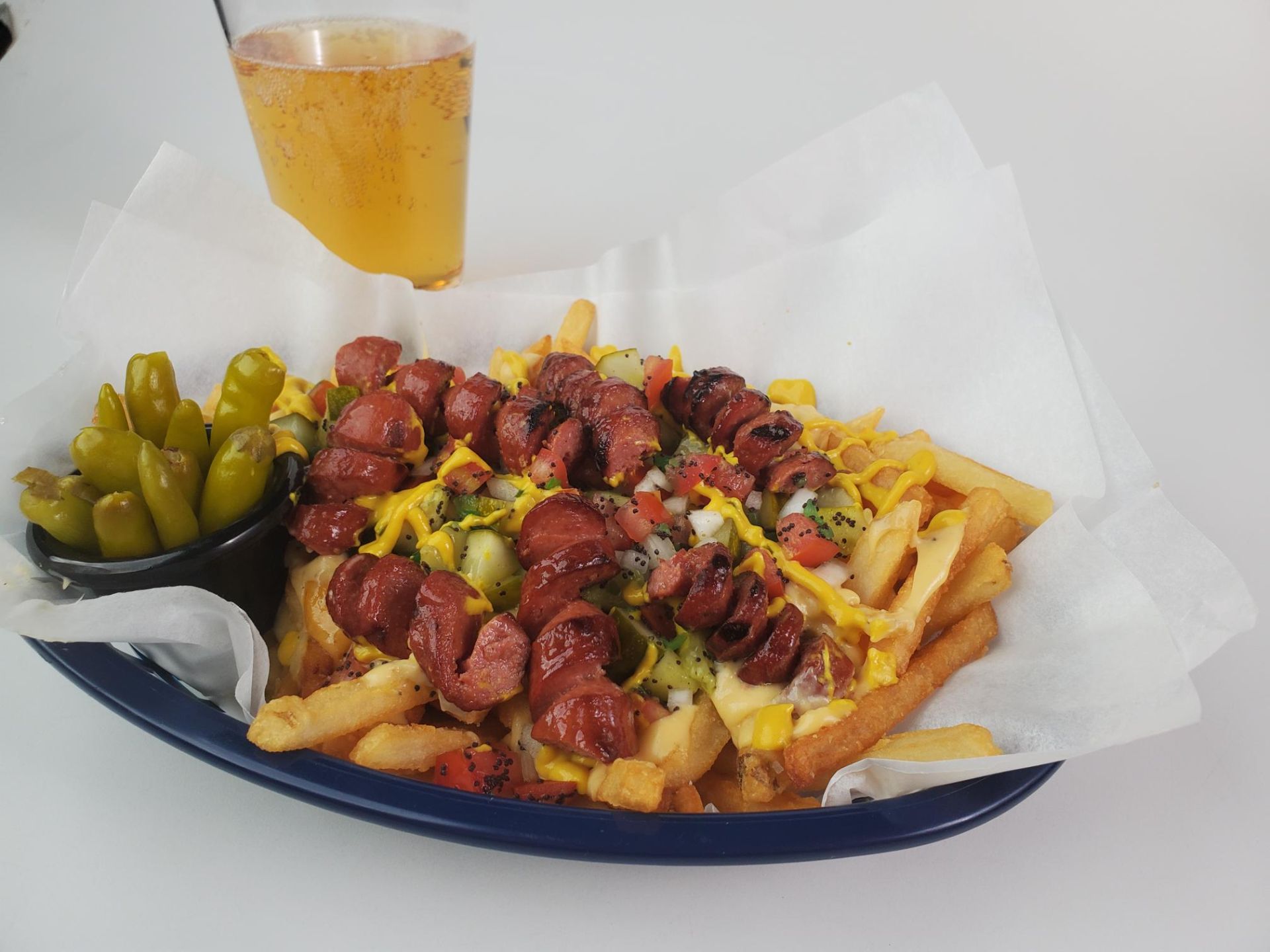 poutine with hot dogs, served with a cold beer