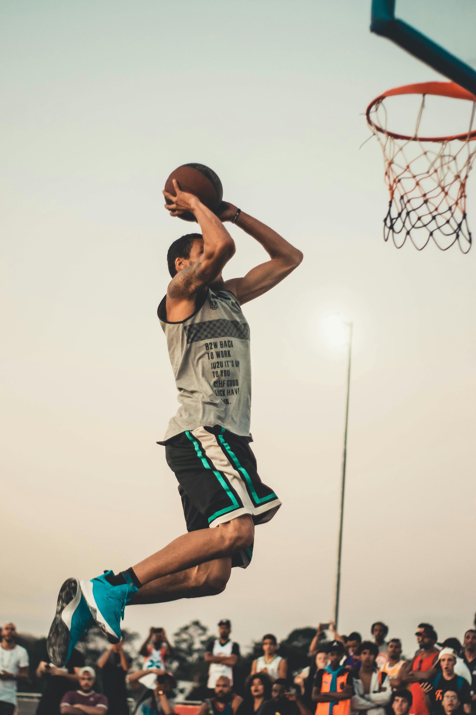 A man is jumping in the air while holding a basketball.