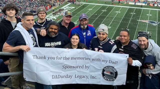 A young man is throwing a football in the air.