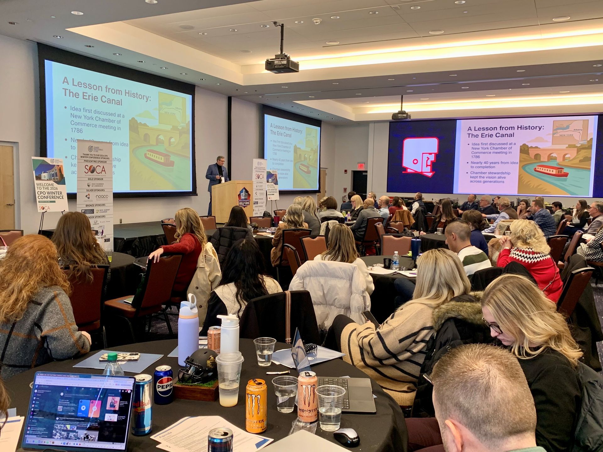 A group of women are sitting around a table talking.