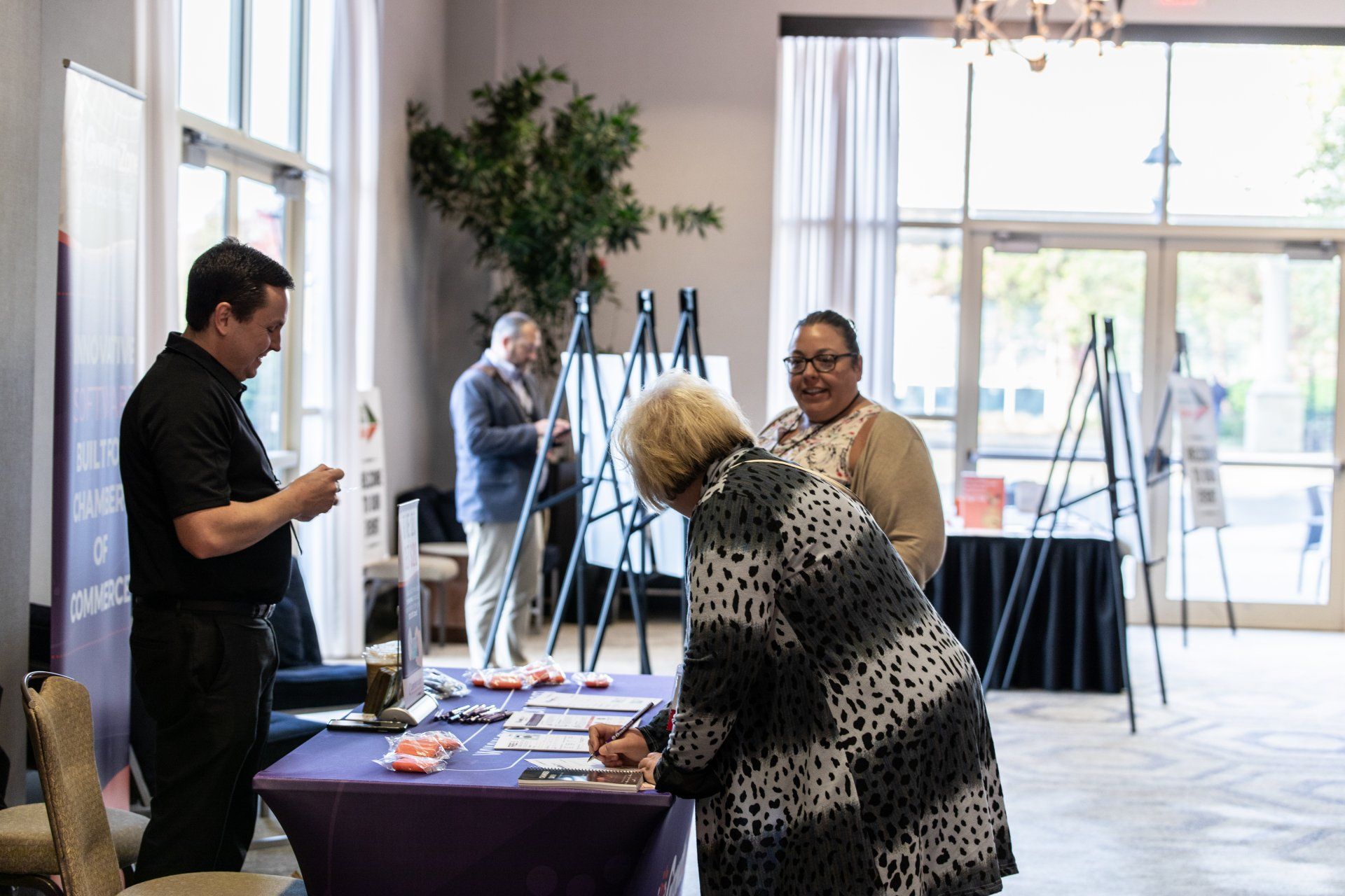 A group of people are standing around a table in a room.