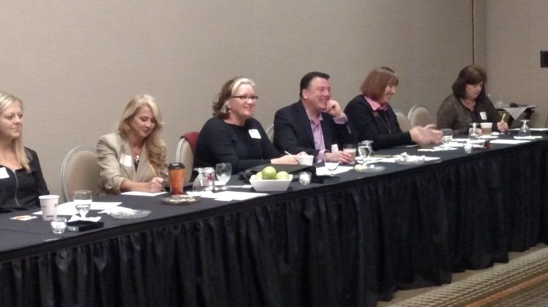 A group of people are sitting at a long table