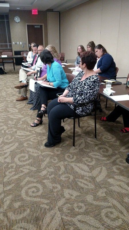 A group of people are sitting at tables in a room.