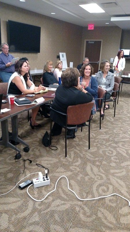 A group of people are sitting at tables in a room.