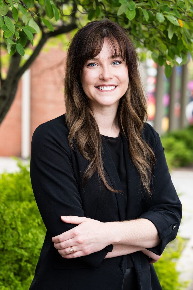A man in a suit and tie is smiling for the camera.