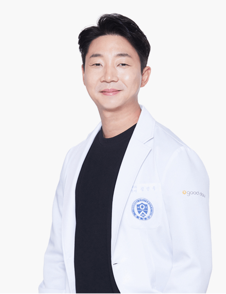 Smiling East Asian man in a white lab coat, chest up. He’s in a studio setting.