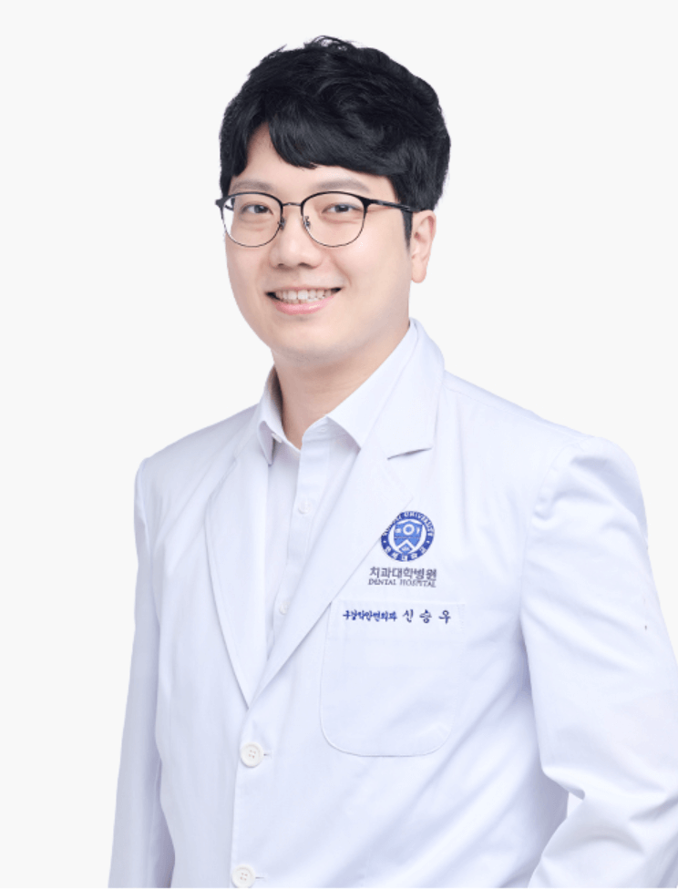 A smiling Korean doctor wearing glasses and a white coat. He is standing in front of a white background.