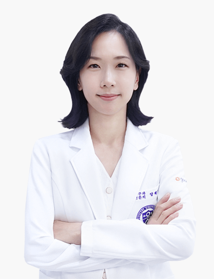 Woman in a white lab coat, arms crossed, smiling. Likely a doctor or medical professional.