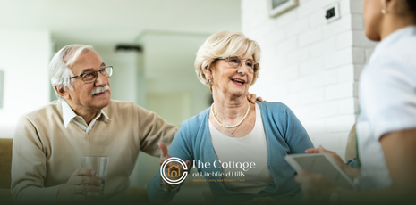 An elderly couple talking to an assisted living staff member about CT state regulations