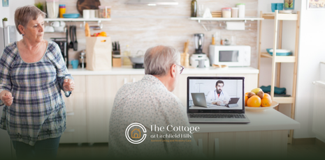 An elderly couple talking about senior living options with a caregiver via laptop 