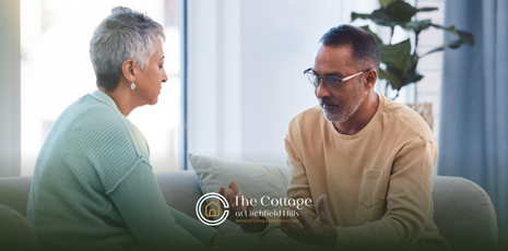 A man talking to his senior mother, who is unhappy in senior living
