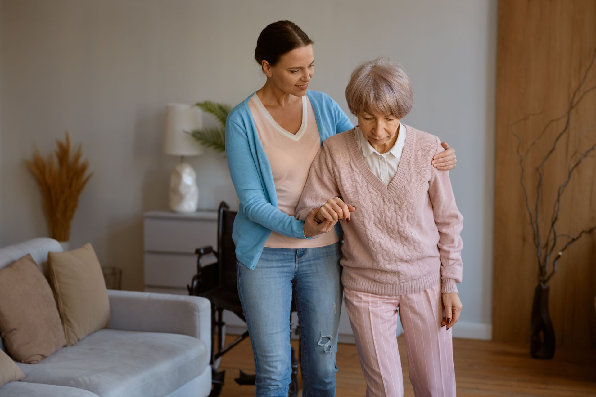 A daughter is assisting her elderly mother