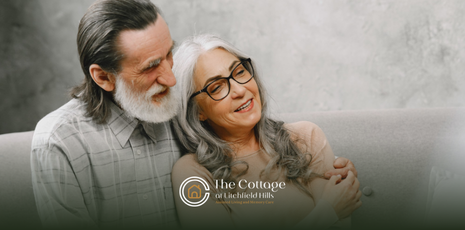 A senior couple sitting on a couch together