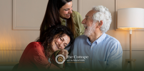 A family hugging together, visiting their loved one in memory care