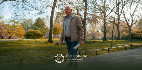 An elderly man walking outdoors