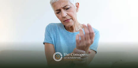 A senior holding her hand, with ailing arthritis pain