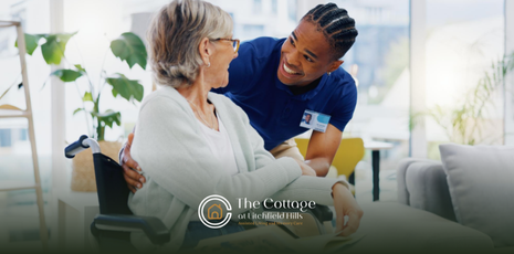 A respite care patient in a wheelchair being assisted by a caregiver