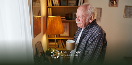 A senior living alone, holding a cup of coffee