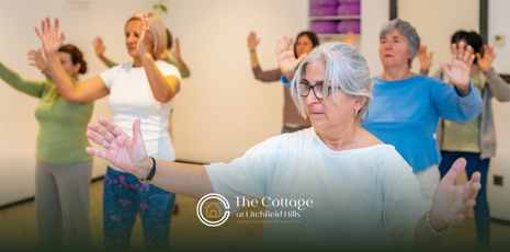 A group of senior living residents dancing together in a hall