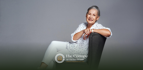 An elderly woman sitting on a chair