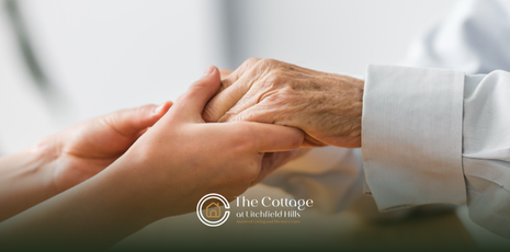 A caregiver holding hands with a senior