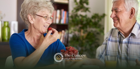 Two senior living residents eating fruits