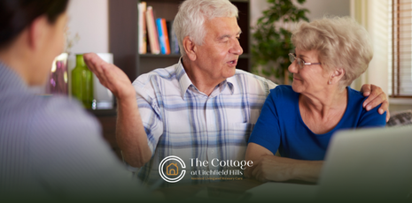 An older couple talks with a professional in an office setting