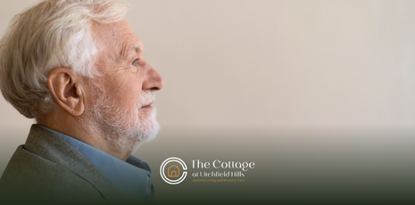 A side profile of a nonverbal elderly man with awhite beard