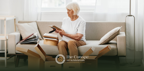 An elderly woman is decluttering and organizing in a living room