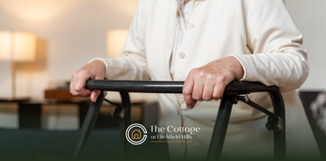 A senior is holding a walker while standing