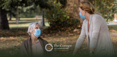 A senior talking to a caregiver during a memory care facility tour