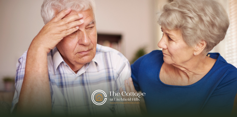 An elderly woman is talking to her husband with dementia