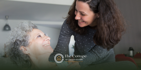 A caregiver talking to an assisted living resident