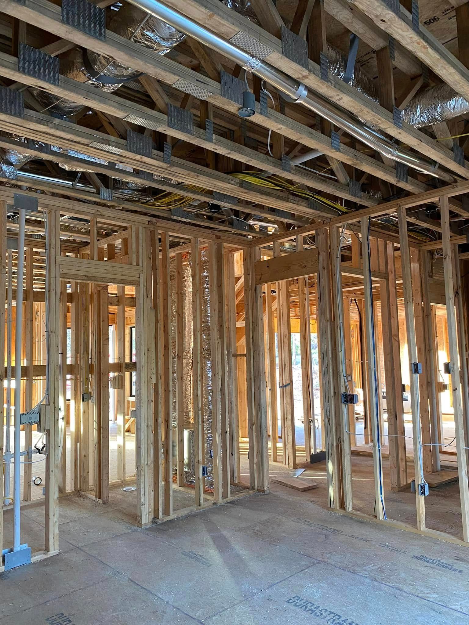 The inside of a house under construction with a lot of wooden beams.