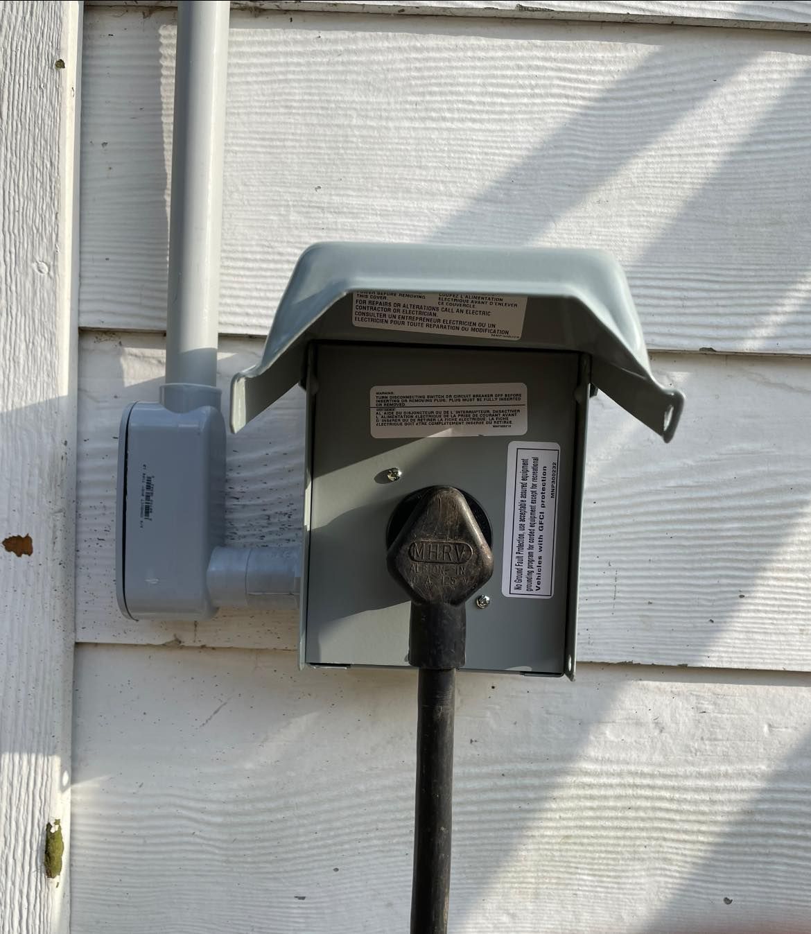 A power outlet on the side of a house