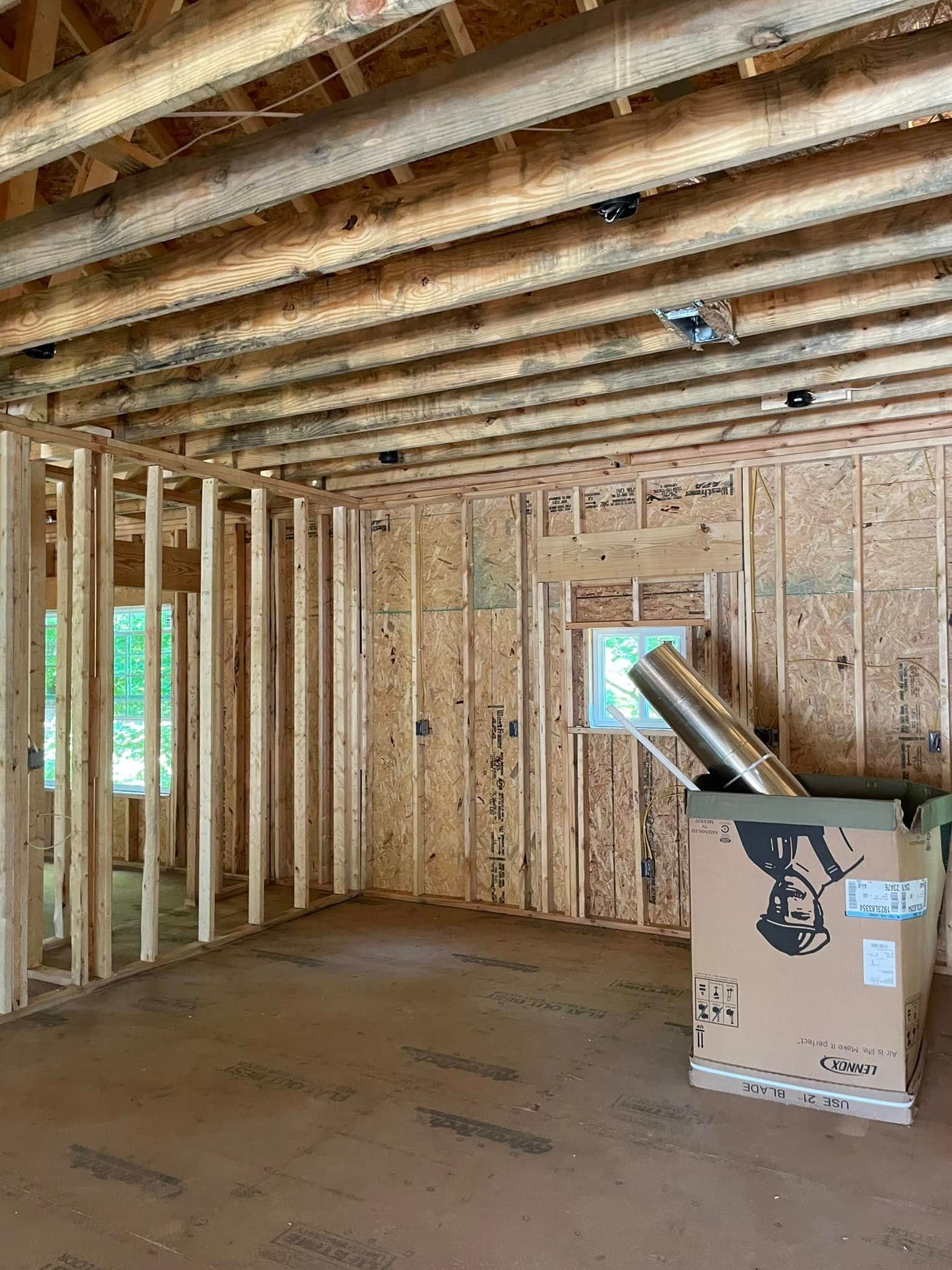 A room in a house under construction with a box on the floor.