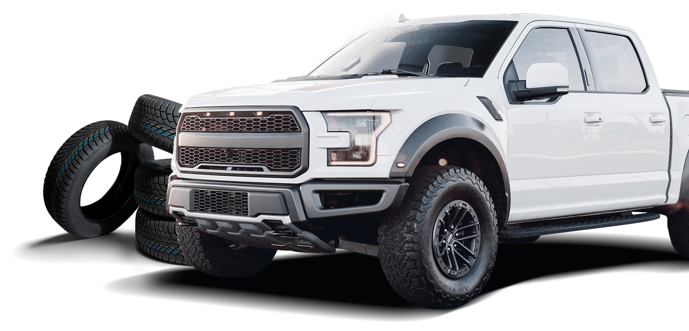 White Ford F-150 truck parked next to stack of tires | Marlin's Auto Service