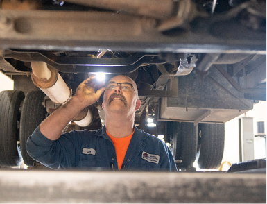 Our expert technician working below vehicle inside our garage in Lynden, WA | Marlin's Auto Service