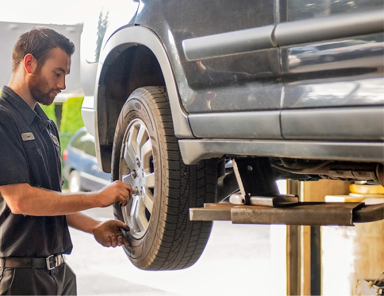 Our skilled technician working on adjusting a wheel on a vehicle in our garage in Lynden, WA | Marlin's Auto Service