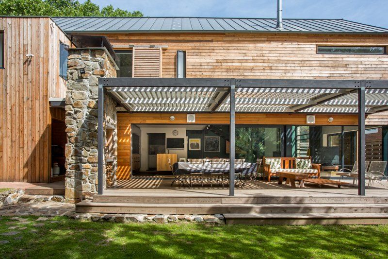 The back of a wooden house with a pergola and sliding glass doors. 7 Lemon Lane – Newlands