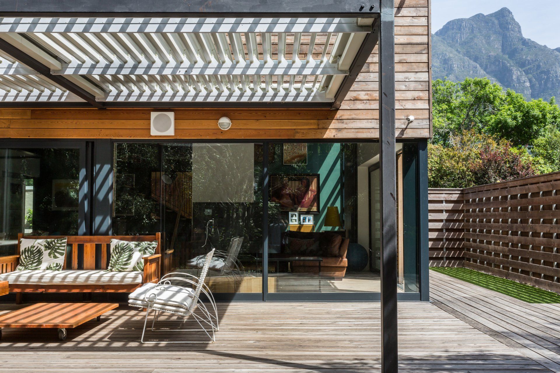 A modern house with a wooden deck and a pergola. 7 Lemon Lane – Newlands