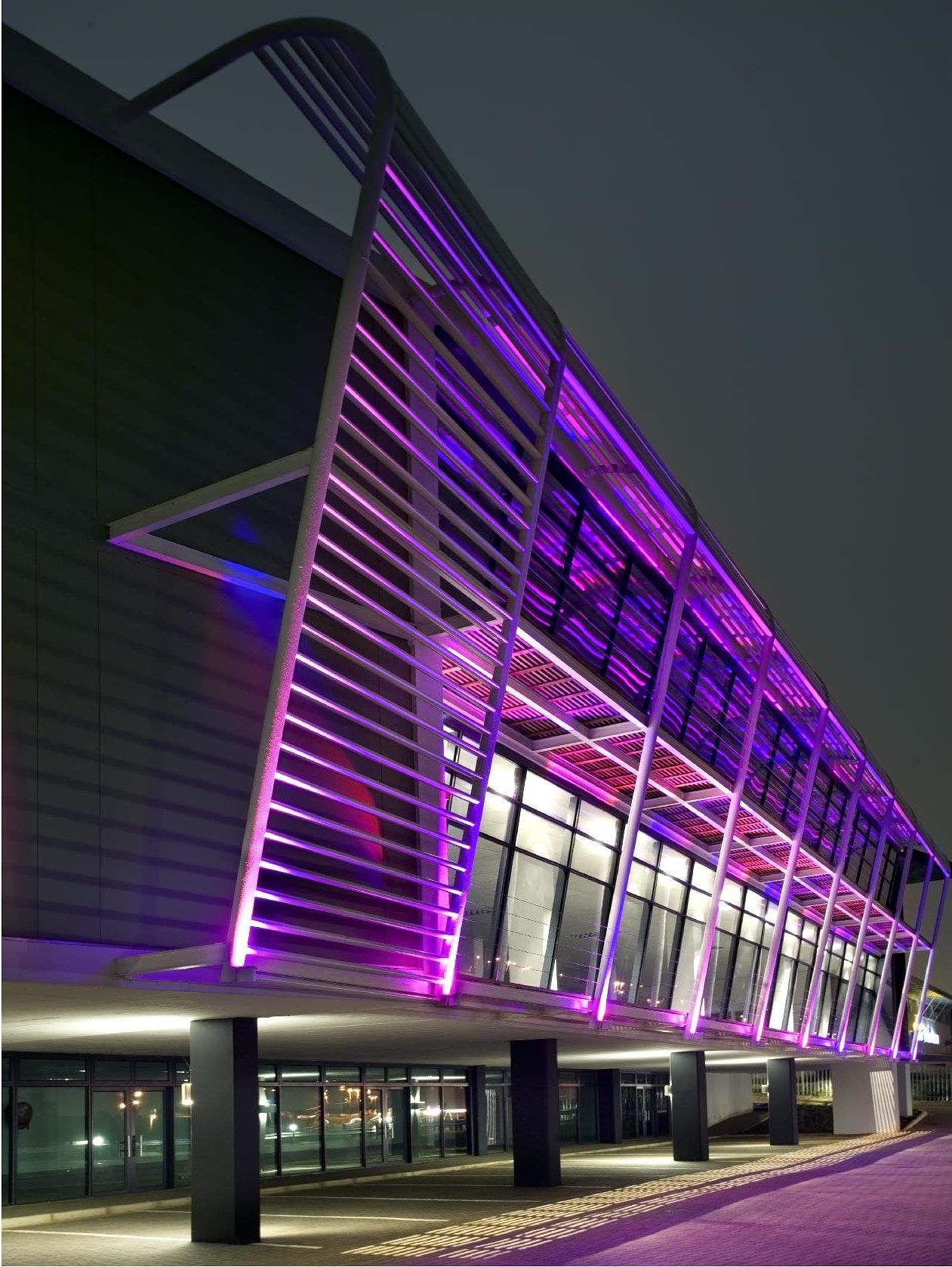 A building with purple lights on it at night. SARS – Umhlanga
