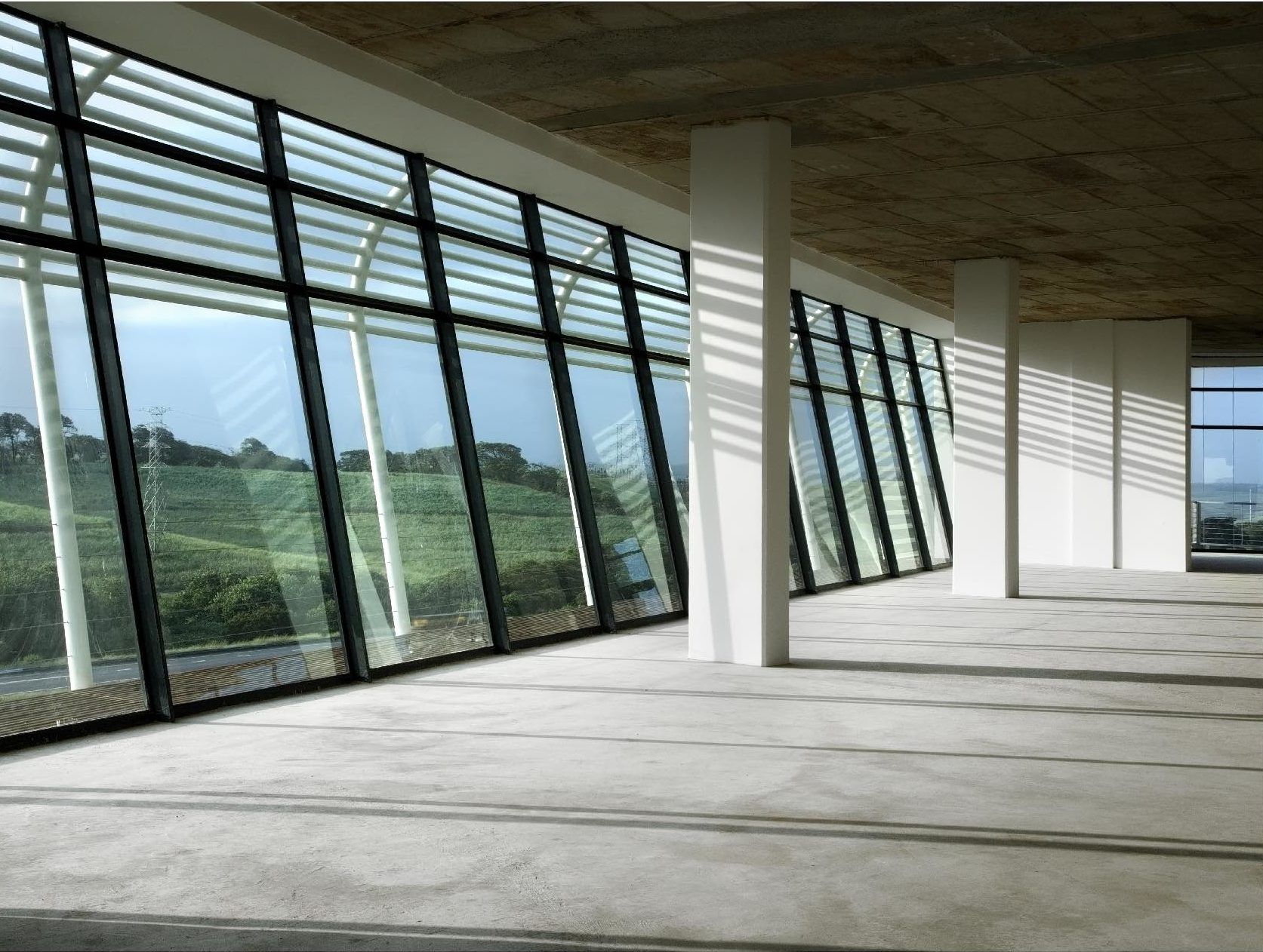 A large empty room with lots of windows and columns. SARS – Umhlanga