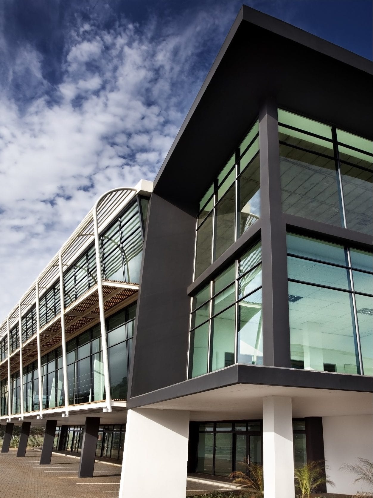 A large building with lots of windows and a blue sky in the background. SARS – Umhlanga