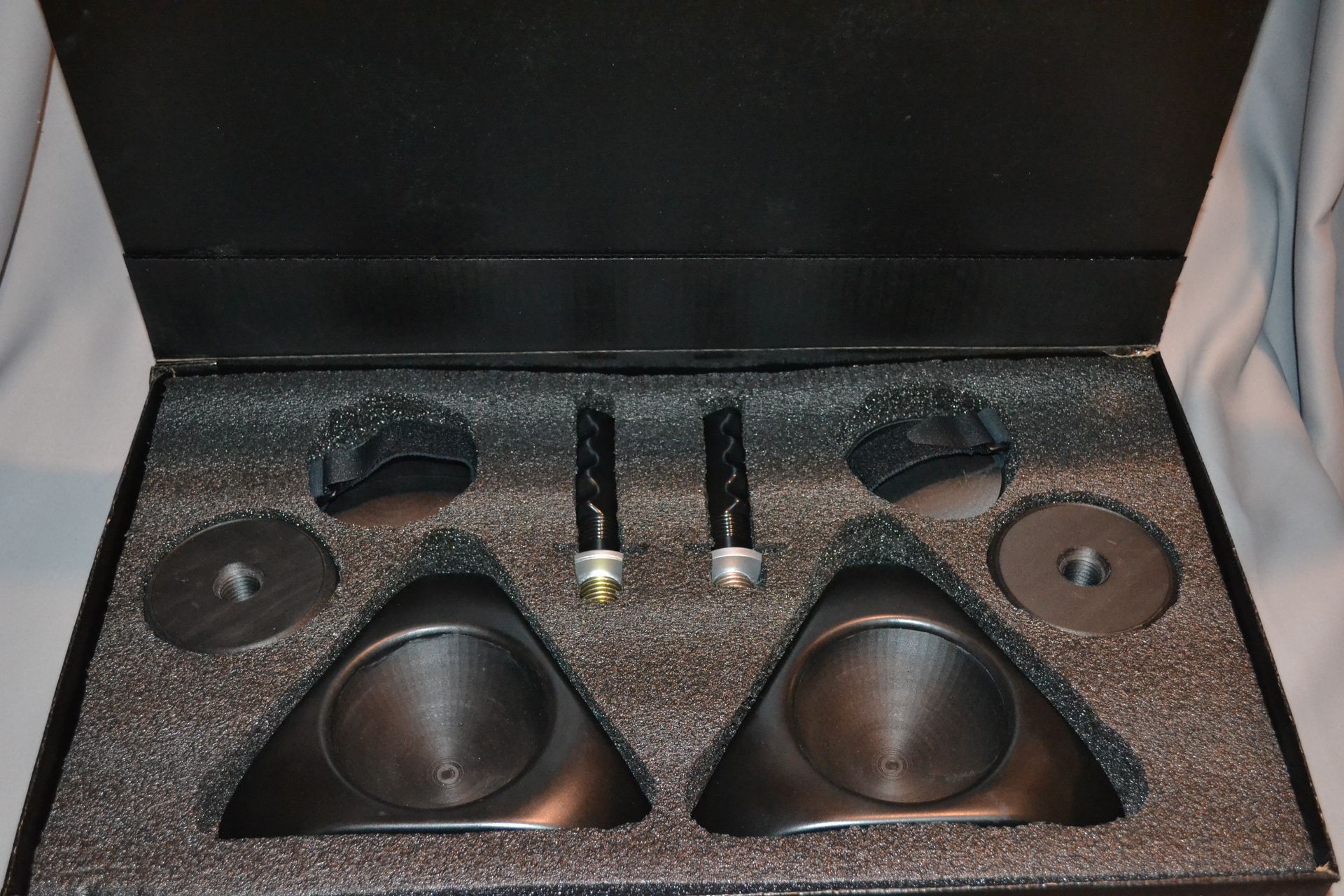 Two black TriGlyde devices, each with a handle, orange lettering, and small lights.