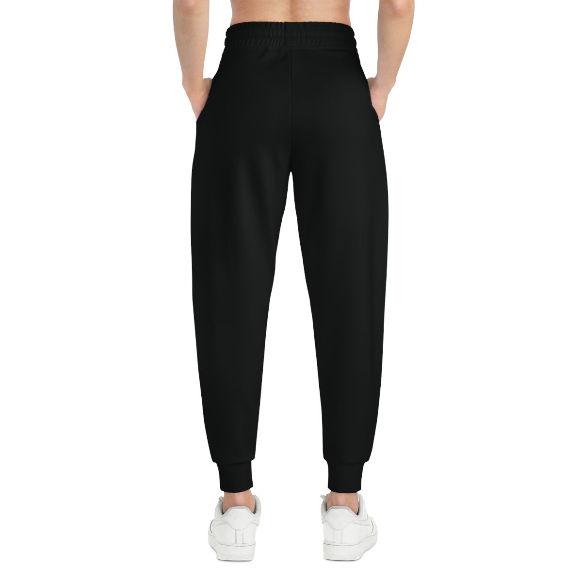 Black joggers with white drawstring and logo, worn with white sneakers.