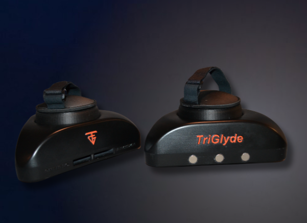 Two black TriGlyde devices, each with a handle, orange lettering, and small lights.