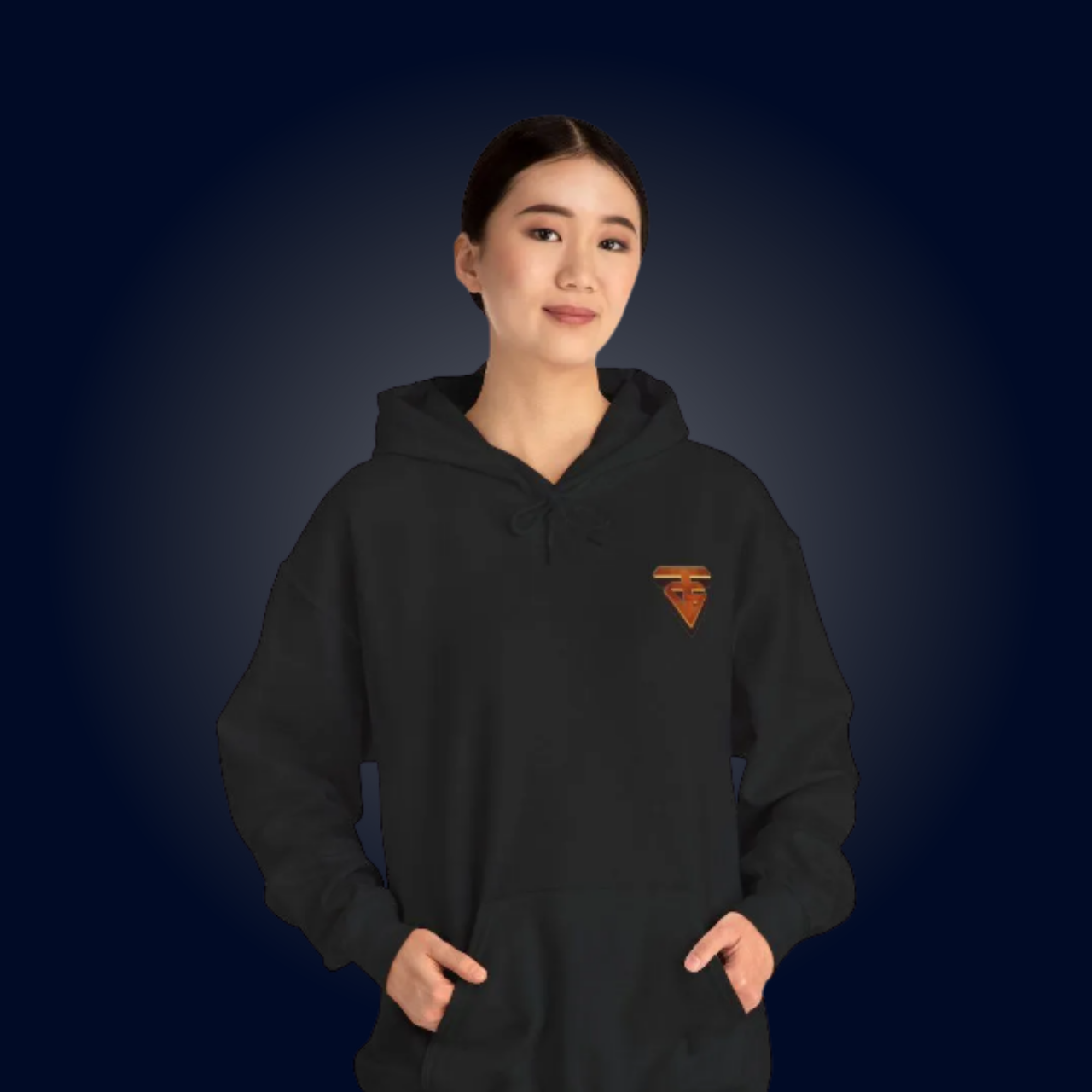 Woman wearing a black hoodie with an orange logo, hands in pockets, smiling against a blue gradient backdrop.